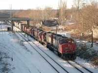 RaiLink Southern Ontario took over the old CN Stuart St yard on Dec 15, 1997. So, this image is of the last of the CN presence leaving town the day before. The 'end of the line' resulted in CN 7027, 7127, 7280, slug280,and 1371 as well as a lot of freight cars being lifted by #449's CN 9406 and 9513 and being shuffled off to Niagara Falls to make it a clean start for RaiLink. It wasn't long, about a year when RailAmerica took over, and then Genesee Wyoming Canada moved in and after only 6 years the yard is rumoured to be reverting back to CN in mid-December 2018, 21 years less a day since this photo from the John St. N was taken.
On the right is the support structure for the old Hughson St bridge and in behind, James St N overpass. Left is part of the old CN Station complex and needless to say this area has completely undergone change since the West Harbour GO station has been constructed beyond James N bridge, on the left side.