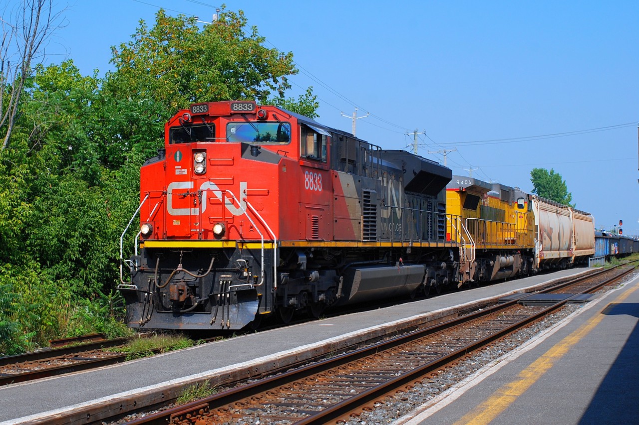 CN-8833 SD-70m2 leading loco with GECX 9406 pulling a convoy of 8,000 feets going to Toronto on CN-route x-321