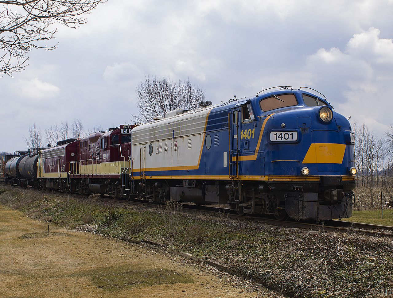 From one shortline to another! Again while on a week's vacation with my family in mid-April, travelling on our way home we stumbled upon the OSR coming back from switching in Tillsonburg. Finally running along Hwy. 19, and parallel to the train it was a catch alone to see three engines. However, the bonus for me was seeing 6508 in the consist. Racing to the next sideroad, we made it just before the train did. Here, with 1401 leading the way, 1594 and 6508 tag along on their way back to Ingersoll.


Current rumours have the OSR painting one of their engines in their livery. It could be a matching pair, or trio. Could anyone imagine if this does happen? Oh these tracks would be lined with us foamers seeing matching sets run again!