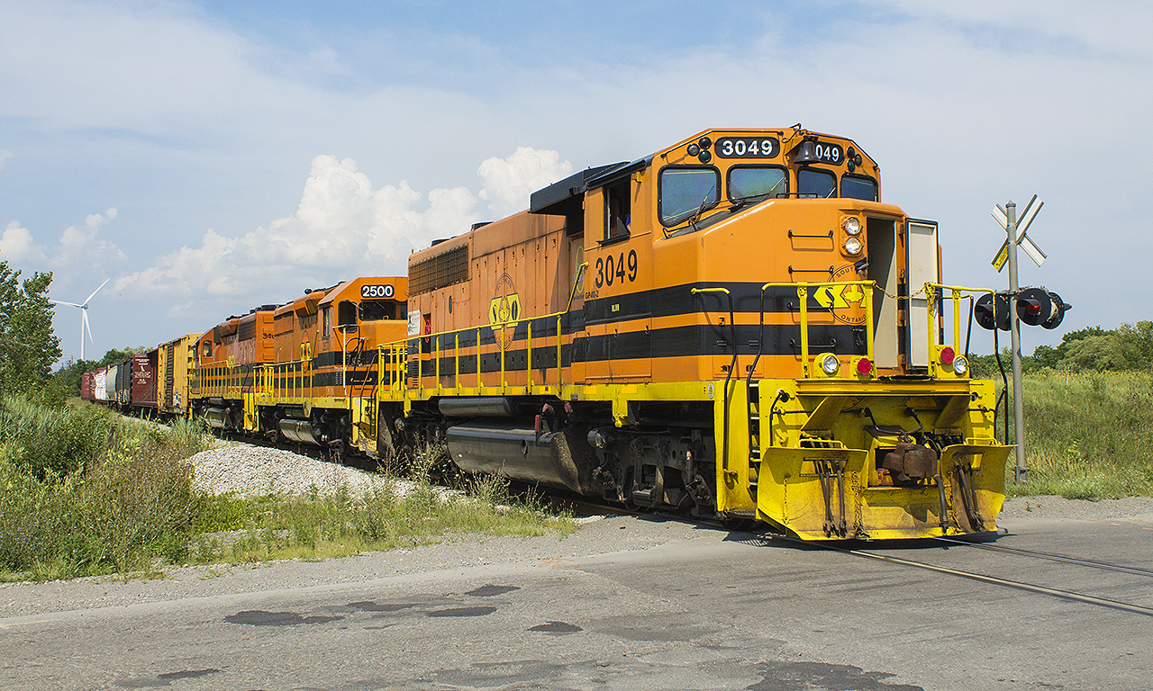 Back in May I had an opportunity to photo what I considered would be my last shots of the Southern Ontario Railway operating this line. However, I was lucky enough on a wonderfully sunny Sunday afternoon of the Civic Holiday weekend to find the SOR working away. Here, and with a few weeks left before CN takes over operation of it's 'former' Hagersville Subdivision, SOR 3049 along with QG 2500 ad SOR 3404 pull a string of cars to drop to their various customers in the Nanticoke Industrial Park. 


Thank you goes to the employees under parent company Genessee & Wyoming. Your patience with us foamers is appreciated, and we hope for you nothing but the best despite the turn of events. We will miss seeing you, along with your standout orange, yellow and black engines.
