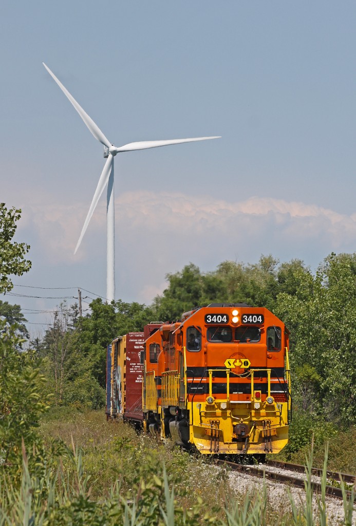 Out for a Spin. After dropping 30 or 40 cars off for SOR 2301 at  IOL, SOR 3404 and 2500 bare down on Haldmand Road 3 on the way to Stelco’s Nanticoke works to drop off a few empty coil cars.