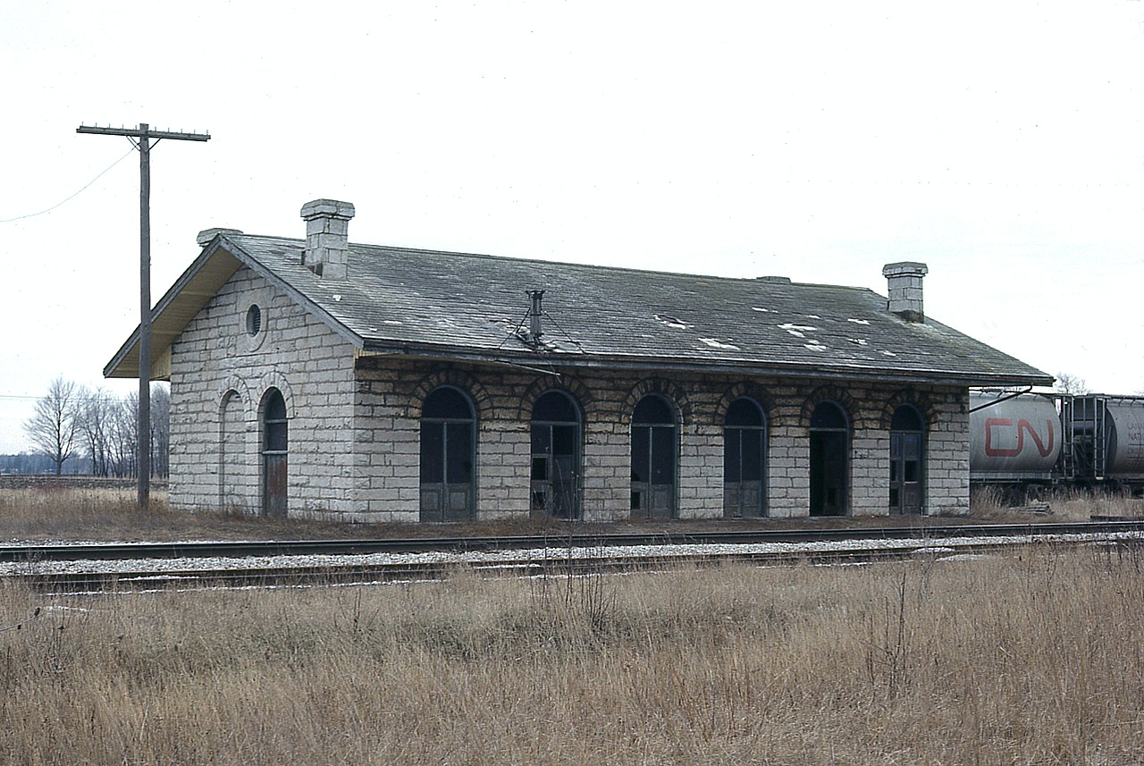 Yes, this old stone station looks a lot like the one over at Port Hope and many others that used to stand along the line between Toronto and Montreal. It should. Same builder, same plans.  At St. Mary's Jct the line from Stratford branched off, one to London the other over to Sarnia. This was once a very busy place, with a turntable, warehouses, stock pens as well as a large roundhouse. It even had Thomas Edison, the inventor, working here for a bit; but he quit after being caught sleeping on the job.  The story is on a  plaque recently erected in front of the station along with a tribute to the historical significance of this beautiful old building, which still stands in situ, surrounded by fencing and a heck of a lot of foliage. It is quiet around there now, although new housing is closing in on the once wide open farmlands...........the line to London still active but the other track was taken up in 1990.