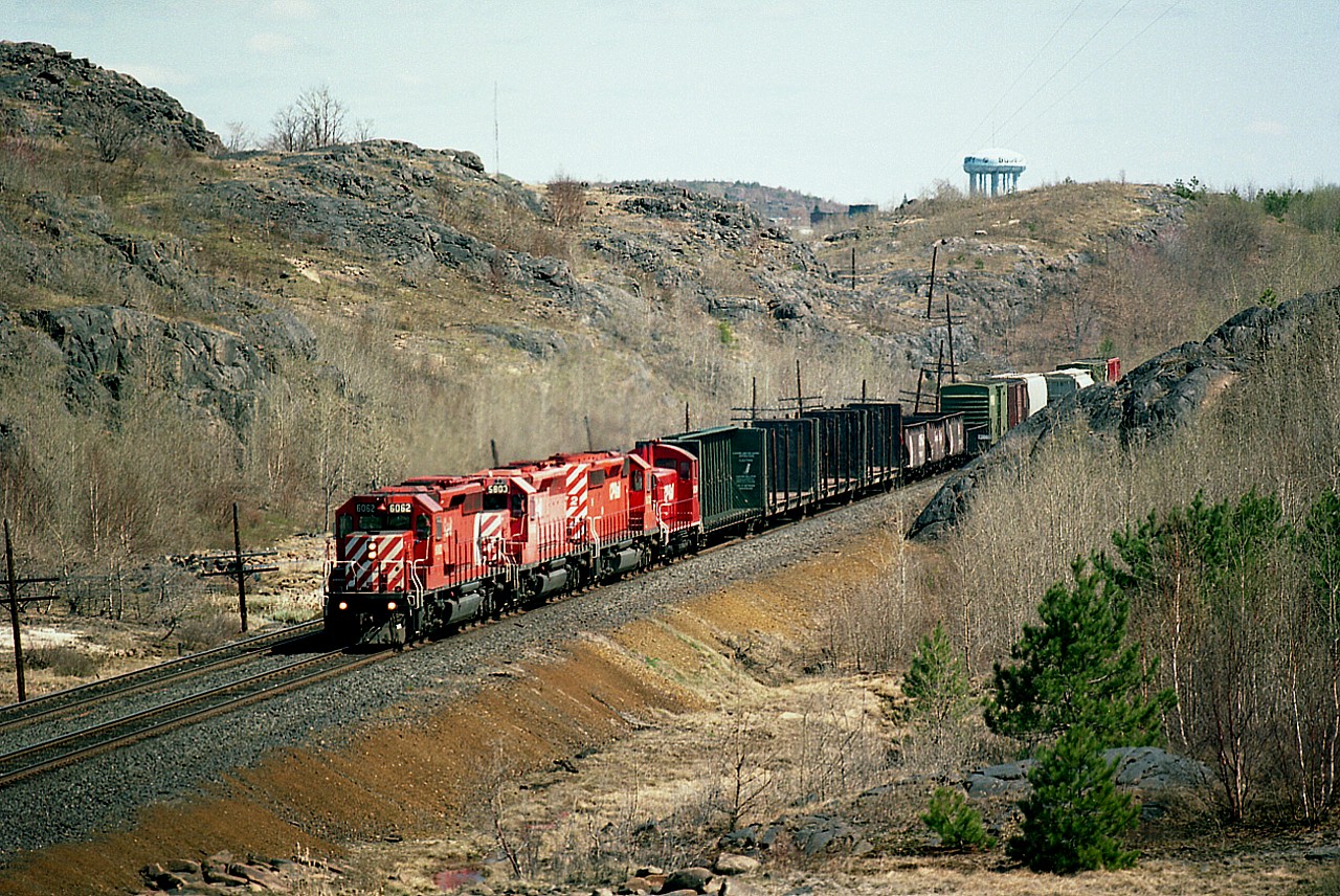It looks as though I am way out in the boonies, but the fact is, Sudbury is just beyond the barren hillside. The water tower is the proof.  The fact that it is still April and the foliage has not yet taken bud makes this scene all that much more desolate looking.  I'm on the shoulder of La Salle Blvd on the west side of town, and have captured CP 6062, 5808, 6072 and 8124 as it heads westward on a nice sunny mid-afternoon.
