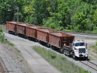Brandt R4 Railcar Mover CN 175529 with 5 empty ballast hopper cars is heading toward the Oakville Sub. <br>
The R4 has a retractable front coupler, 50000 lb Tractive Effort, rail speeds up to 40 MPH forward and 25 MPH in reverse, and highway speed up to 65 MPH. There is a "Freightliner" badge at the top of the radiator intake.<br>
The train is running on the Cowpath side of the Bayview Junction wye after dumping ballast along the Dundas Sub.
