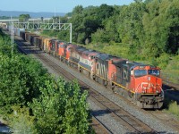 CN train 422 is passing under Oakville Sub intermediate signal 348T1 with seven engines on the head end - the first 4 are running. The BC Rail pair that Stephen Host caught powering CN 383 at Speyside three days earlier are fourth and third engines on this run.<br>
The SD75i's that are 5th,6th, and 7th show several signs of recent attention - well-cleaned paint, some re-paint, some new radiator fans in primer, new shock absorbers and steering links in the trucks. <br>
After setting off head end cars from Aldershot East and lifting others, 422 will continue to Macmillan Yard with  802 axles ( 7 engines and 190 cars ) !  