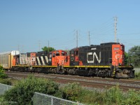 Running long hood forward as built and remanufactured, GP9rm CN 7029 of CN switcher class GS-418b leads other-way-around road-switcher sibling CN 4118 and GP38-2w CN 4771.<br> Train 556 has just entered the Oakville Sub from Aldershot yard, heading eastward to Oakville Yard with all multilevel autoracks - presumably empties to be loaded with new vehicles from the Ford Oakville Assembly Complex.