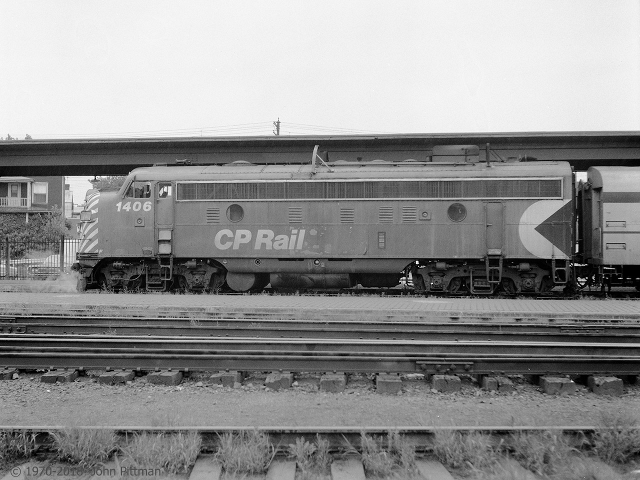 FP9A CP 1406 and train are making a scheduled station stop at Trois-Rivieres QC before continuing to Quebec City.  CP 1406 is equipped with icicle breakers that protect the dome cars of "The Canadian" in tunnels. 
All the passenger trains I ever saw in T-R were hauled by one EMD or GMDD locomotive.
Most frequently seen on passenger trains here in 1970-71 were CP's remaining E8A units, 1800 or 1802. (I wondered about CP 1801, but it had been scrapped after a crash in late December 1968.)
Second most common were CP 406x series FP7A units in maroon and grey. CP Rail red passenger engines were least often encountered on my intermittent visits to the station. 
By around mid-year in 1971 all the passenger trains I saw in T-R were sets of Budd RDC's.