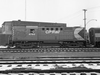 Clean and glossy in fresh CP Rail paint, the crew of MLW RS-18 CP 8790 awaits clearance to take their train eastward to Montreal one afternoon in the winter of 1970-71. Behind it is a CP MLW FB or FB-2. <br>
The posture of the crewman on the left is expressive, and his hat would go well with a steam engine.<br>
Some years previously, the tunnel from Trois-Riviers station to the between-tracks platform had been sealed off.
