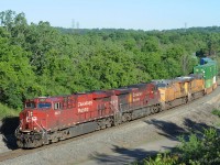 A CP intermodal train heads downhill south on the Hamilton Sub with double the usual number of locomotives. The train is approaching the CTC section that begins at the Desjardins canal.<br> The CP engines are a GE ES44ac and GE AC4400 with steerable trucks. The UP engines are both GE ES44ac that have UP designation C45ACCTE.<br> The 7:51 AM morning sunlight was just high enough for tree shadows to be off the tracks. 