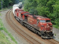 CP train 246 powered by an original GE AC4400 and a re-manufactured AC4400CWM heads south on the Hamilton Sub east track.  The parallel west track is one side of the Aberdeen wye, with junction signal 589. <br>  Train 246 has just emerged from under Main Street bridge and is approaching Dundurn Street bridge. Single-track Hunter Street tunnel is beyond. 