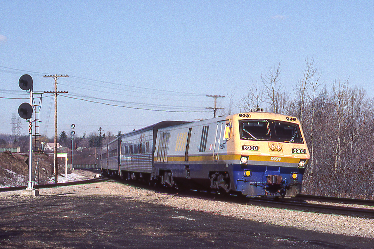 VIA 6900 is eastbound through Hamilton West, Ontario on March 27, 1984.