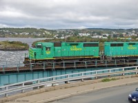 New Brunswick Southern GP38-3 units 2610 and 9802 lead a freight train west over the ex-CP bridge that crosses the lower St John River. The engines are just beyond the girder truss section. Vantage point is the St John NB information centre building near the Reversing Falls viewpoint. <br><br>
NBSR 2610 was built by EMD in 1965 as GP35 SP 7768. It was upgraded into a "GP38-3", losing its turbocharger and middle radiator fan, presumably converted from 567 to 645 diesel engine and electrically upgraded. It became SP 6665, SP 6308, and CIC 110 (Cedar Rapids & Iowas City). It joined the NBSR roster in 2007, arriving in the UP paint scheme.