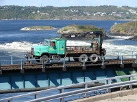 A New Brunswick Southern utility truck crosses the turbulent lower St John River on the ex-CP bridge. The reversing falls is just downstream (more like rapids when I was there, depends on the state of the tide). <br>
New Brunswick's Irving Corporation acquired the former CP (Canadian Atlantic Railway) network in New Brunswick, and operates it as the New Brunswick Southern Railway. They also have some lines over the border in Maine.