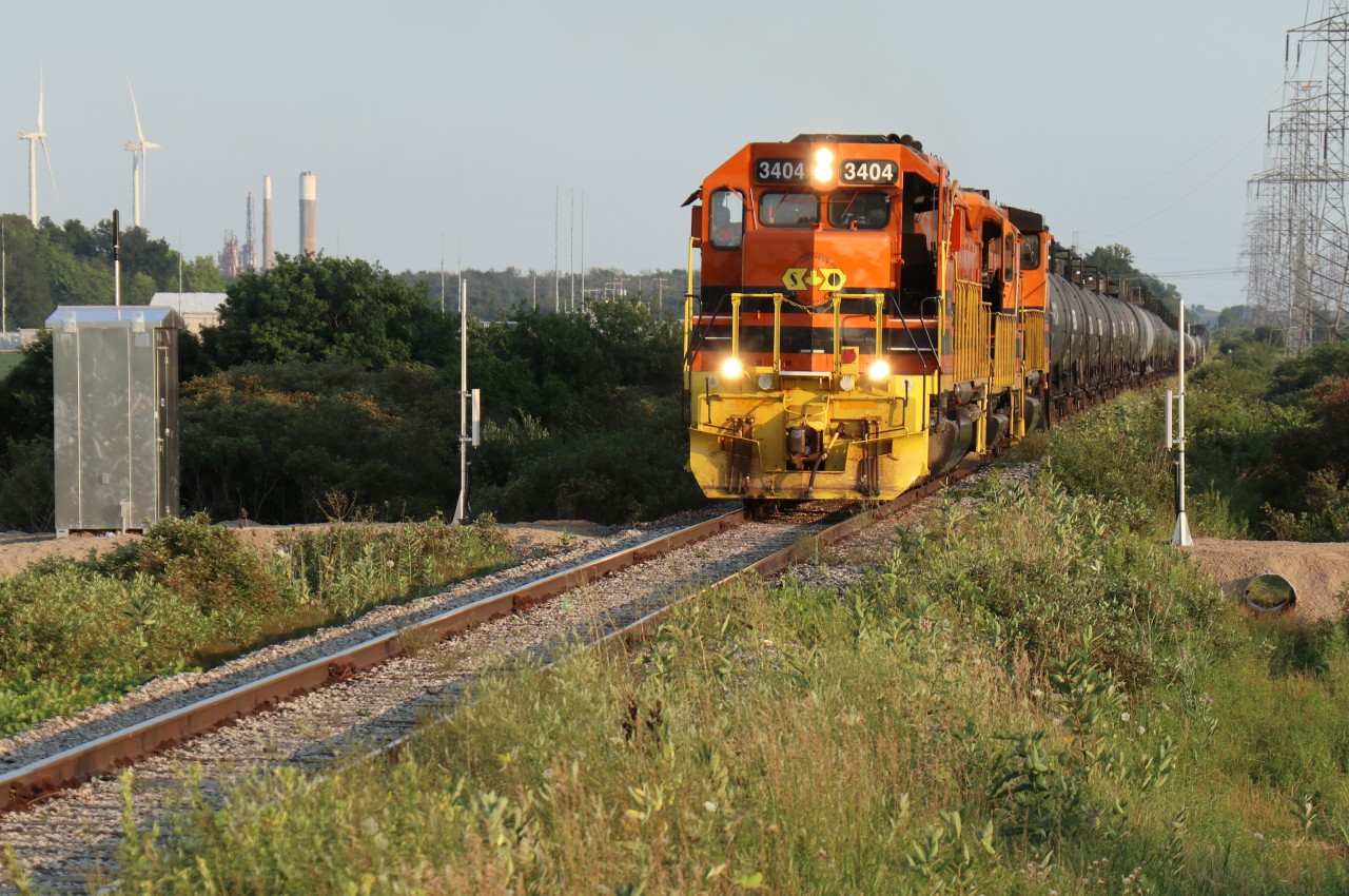 RLHH 3404, QGRY 2500 & RLKK 3049 with 70 cars in tow are about to split the uprights of one of CN Rail's recently installed Single Track AEI Systems enhancing the Hagersville Subdivision. This set of scanners / track sensors is located at MP 2.61 Walpole Concession 6 with the north configuration positioned at MP 7.22 Walpole Concession 11. RLHH 597 will soon be tied down at the extreme north end of Garnet Yard to await her new crew before departing for Paris West. This was truly an interesting day trackside with special thanks and appreciation to friendly crew of RLHH 3404.

Railfans familiar with the Hagersville Subdivision may be interested to know that a Communications Tower has been installed at the south end of Garnet Yard MP 4.7.  Change of plans … the 'ole' Station at Hagersville is now considered unsafe and will undoubtedly be torn down. Previously buried cabling has been rerouted in preparation for two portable trailers.  Interesting developments!