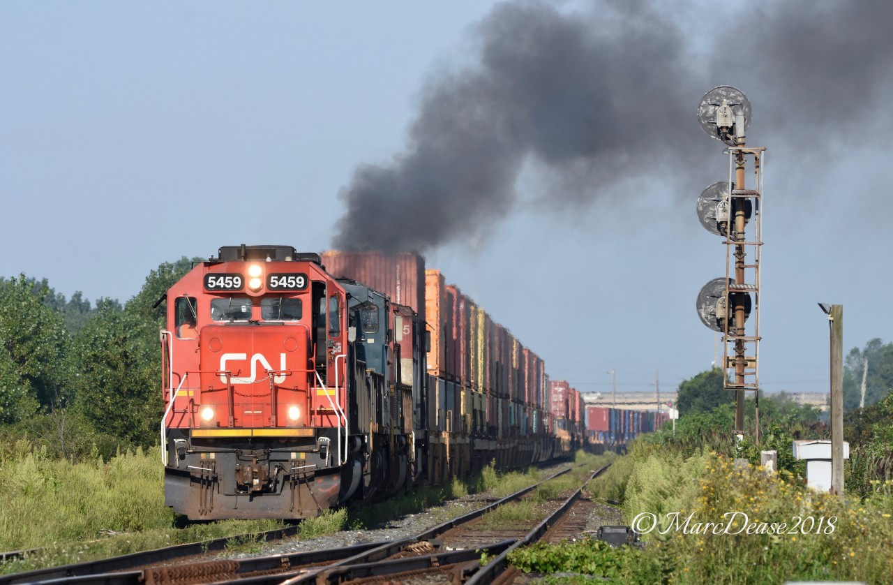 Train 148 led by CN 5459 departs Sarnia with a smokey 3rd trailing unit(BCOL 4625).