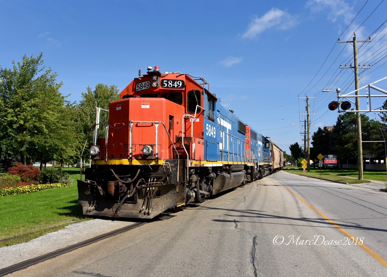 Sunshine, blue skies and a pair of GTW units working the IOX and grain elevator job in Sarnia made my day today. GTW 5849 with GTW 6420 shove 2 empty hoppers across Front Street bound for the elevator where they will drop the empties and pick up 6 full cars.