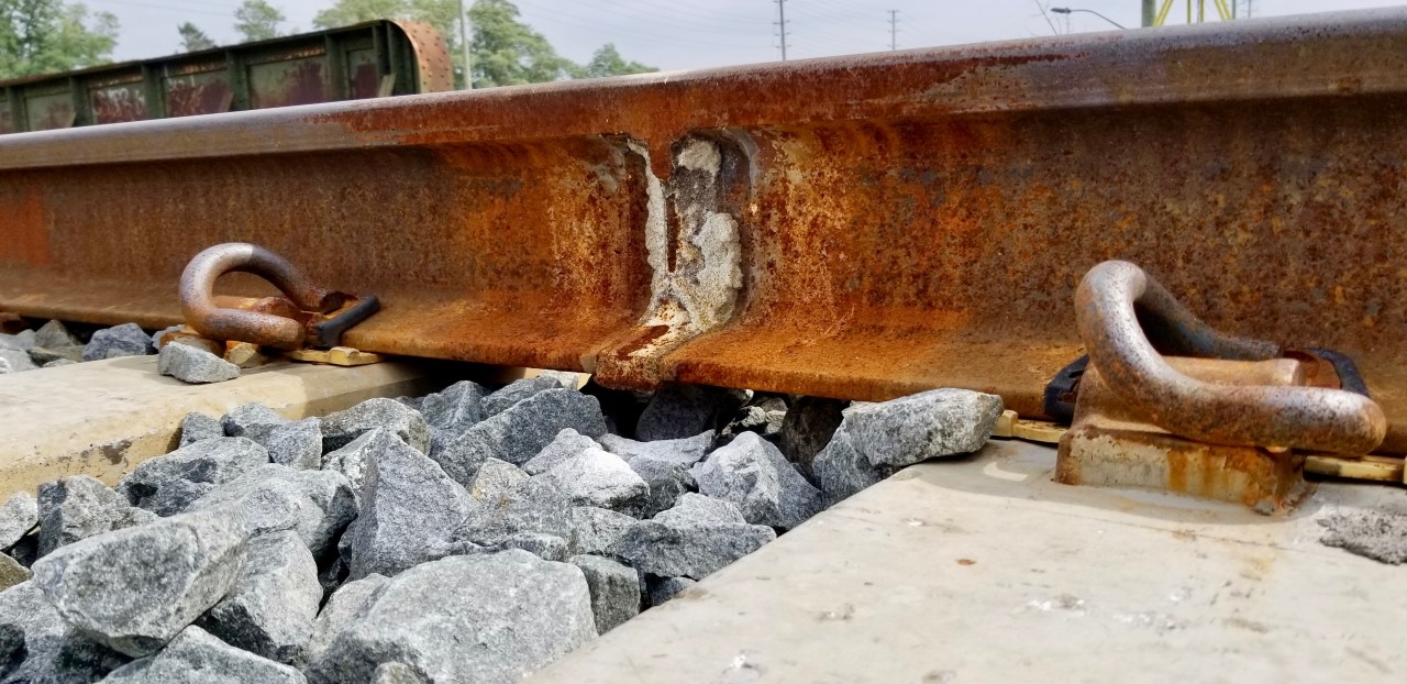 So did you ever wonder how they connect 2 pieces of ribbon rail and the process it takes?

Railroad tracks used to be joined with fish plates, metal gussets bolted across the sides of the joints between tracks. Now they are welded into continuous ribbons of steel. But the process is different than you might imagine; instead of using arc welders, oxy-acetylene welders, or gas shielded welding equipment, the people doing the work are likely to use a process called thermite welding.

After the ends of the rails have been ground clean and positioned approximately one inch apart they are encased in a hollow form and preheated with a powerful torch. A crucible is placed over the form and filled with thermite, a readily ignited aluminum-based powder that burns at about 4,500 degrees F. After being lit with what looks like a 4th of July sparkler the thermite turns its constituent parts into molten metal, which pours into the form below—filling the gap between the rails and welding them into a single piece of steel. The form is removed, the excess metal is beat or chiseled away, and the joint between the rails is ground smooth. Start to finish, the process takes maybe an hour to perform.

These newly bonded rails are held to the concrete ties with Pandrol clips. A very different means to hold the rail to the tracks than the traditional railroad spike and wooden tie.