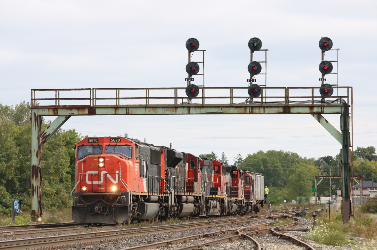 M385 is backing up to their train again after dropping off some tankers in the yard.