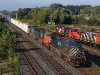When I framed up this shot this morning it reminded me of one I posted on this site from years ago of a CP trackage rights train passing CN local power working the yard behind. So much has changed at Aldershot over the years. New signals, new track and the removal of the old cold storage building, not to mention the fence now erected along the mainline. Well I guess time marches on and it was nice framing CN 422 today with a bit of a colourful consist as it slowed to work the yard. Local power with a couple of veterans up front can be see building one of the day’s trains. 