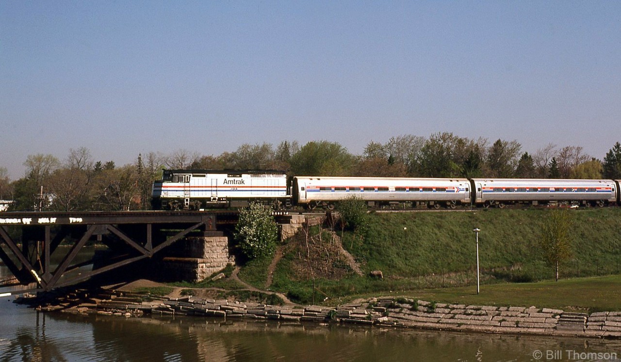 The joint VIA/Amtrak "Maple Leaf", lead by Amtrak F40PH 344, crosses the Credit River Bridge as it heads westbound on CN's Oakville Sub through Port Credit, Ontario.