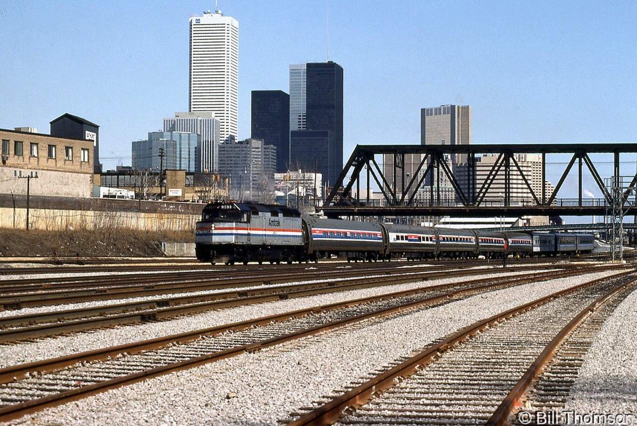 The joint VIA-Amtrak "International" is seen passing under Bathurst Street Bridge on a sunny Sunday. Amtrak F40PH 363 leads five Amfleet passenger cars, with three VIA Tempo cars tacked on the rear end.