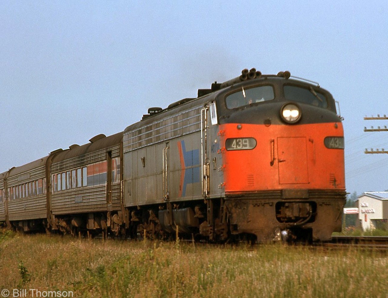 When Amtrak was formed to take over passenger services from railroads in America it acquired a varied fleet of secondhand passenger cars and locomotives, including an assortment of EMD E-units from a few different roads. Here, Amtrak E8A 439 (formerly Richmond, Fredericksburg and Potomac RR 1007, repainted in the early Amtrak livery) hurries the Niagara Rainbow through Tilbury, Ontario over the Conrail CASO Sub in August 1976.