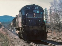 On the main track at Mackin, VO symbol freight is waiting on a meet with southbound train. Notice the white flags /white lights indicating "run extra" Williams Lake to Prince George BC. Early spring morning with difficult light for photos. Anyhow, this was perhaps my favorite freight job out of Williams Lake with an early morning departure, a good snooze in Prince George and then a late evening trip back to Williams Lake. Quite often northbound we had work at Williams Lake, setout and pickup, perhaps setout some empty covered gondolas at Gibraltar for copper ore loading. Quesnel we would setout numerous cars and make a large pickup. On the way home from Prince George, the train was easy handling with a lot of TOFC empty traffic, a quick setout and pickup at Quesnel and sometimes making a quick stop picking up loads at Gibraltar.

Special thanks to Joe Bishop for helping with this image.