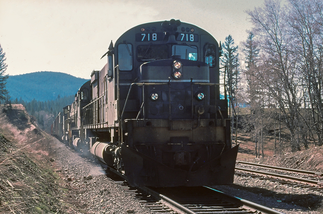 On the main track at Mackin, VO symbol freight is waiting on a meet with southbound train. Notice the white flags /white lights indicating "run extra" Williams Lake to Prince George BC. Early spring morning with difficult light for photos. Anyhow, this was perhaps my favorite freight job out of Williams Lake with an early morning departure, a good snooze in Prince George and then a late evening trip back to Williams Lake. Quite often northbound we had work at Williams Lake, setout and pickup, perhaps setout some empty covered gondolas at Gibraltar for copper ore loading. Quesnel we would setout numerous cars and make a large pickup. On the way home from Prince George, the train was easy handling with a lot of TOFC empty traffic, a quick setout and pickup at Quesnel and sometimes making a quick stop picking up loads at Gibraltar.

Special thanks to Joe Bishop for helping with this image.