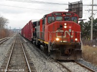 Meeting at Malton: After departing Bramalea GO station, our eastbound GO train on the main (#260, Bramalea-Union) overtakes CN #577 running along the north service track near Malton, which had departed Malport Yard not too long ago and is seen making its way down the Weston Sub to interchange traffic with CP at West Toronto. Even though we have two stops to make at Malton and Etobicoke North, our GO train will easy outpace #577, and it'll likely stay on the north service track until Woodbine East before taking the main and making a run for the CN-CP connecting track at West Toronto (CN Keele). CN #577's real treat was it usually pulled a pair of GP40-2LW's as power, which were becoming difficult to find at the time as CN's once mighty fleet of 278 units had been whittled down to just 60 or so, with many in need of an overhaul and new paint. Sister units 9411 (in ratty zebra stripes) and 9410 (in fresh zebra stripes) handle the usual CP-bound traffic, including a cut of red CP boxes at the head end. GP40-2LW 9410 was the <a href=http://www.railpictures.ca/?attachment_id=1678><b>prize unit</b></a> to catch at the time: for some unknown reason it had been repainted in the long-dead zebra stripe livery at Transcona Shops almost a year earlier, and this fresh repaint was hanging around the Toronto area working freight and local assignments.
<br><br>
Even though Metrolinx had not yet bought the line, the local Weston Sub switcher (CN #579 IIRC) was a night job and the only other freight the line saw was #577 making its daily run down to West Toronto and back to interchange traffic with CP (MacMillan Yard via Malport to CP West Toronto and back). #577 usually ran in the afternoon as passenger traffic was at a minimum, with the exception of the afternoon GO "Bramalea Flip" runs which were easy enough to avoid. However if things got delayed, the CN RTC would have his work cut out for him trying to fit in #577 just before or during the PM GO rush and get it out of the way before anything got delayed (and things could get really FUBARed for Georgetown line commuters if it were to break down and stall on the single track section between Rexdale and West Toronto, which it occasionally did). 