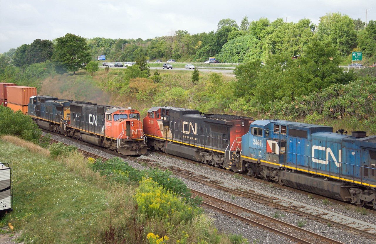 You don't always get to choose when to take the photo, but this one seems to have worked out fairly well!

CN 273(behind C40-8Ws 2188 and IC 2466) meets CN 148 (with CN SD70 5609 and leased C40-8 GECX 9135) beneath the Lemonville Road bridge in Burlington.