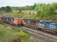 You don't always get to choose when to take the photo, but this one seems to have worked out fairly well!

CN 273(behind C40-8Ws 2188 and IC 2466) meets CN 148 (with CN SD70 5609 and leased C40-8 GECX 9135) beneath the Lemonville Road bridge in Burlington.