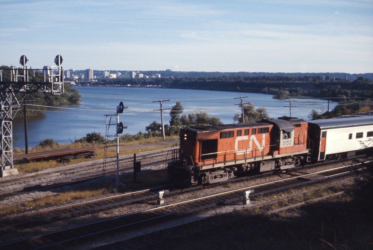 CN train 144 drifts down the grade into Bayview behind Tempo RS18 3152 on a fine September afternoon in 1973. At the time, CN ran four pairs of passenger trains to/from Windsor, one to/from London, three trains to/from Sarnia, and three trains to/from Niagara Falls through Bayview. Still more ran via "the back route" through Guelph and Kitchener.

A great source of old passenger schedules is found here (CN and CP public timetables):
https://www.dropbox.com/sh/1rriwxrhmll3lmr/AAB5P4McatYTnsEYzbLG5kK2a?dl=0
