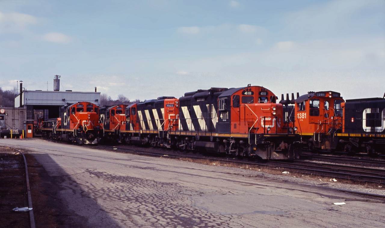 It's a sunny late winter morning in 1994 and the ritual visit to Stuart Street diesel shop turns up an interesting assortment: slug 260 (rebuilt from a GP9) with "mother" 7267, GP9RMs 4111, 4123, and 7030, as well as SW1200RS 1381 and another unit. If you look carefully, you can see another pair of units on the west side of the shop--looks like a pair of "sweeps"!
