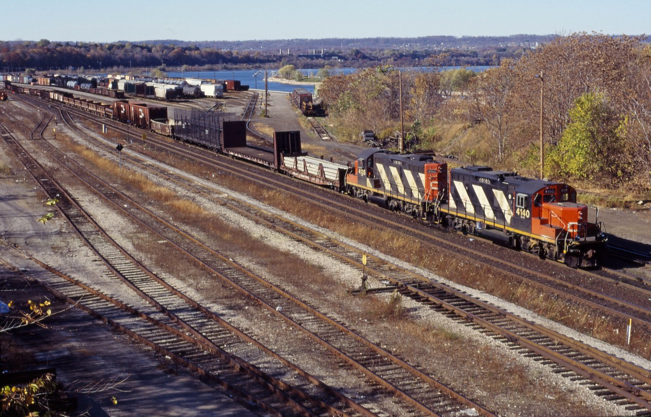 A road switcher prepares to yard its train on a fine late Fall day in 1994. GP9RMs 4140 and 4135 provide the power. In the distance you can see a van/caboose, still in use on many locals at the time.