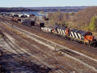 A road switcher prepares to yard its train on a fine late Fall day in 1994. GP9RMs 4140 and 4135 provide the power. In the distance you can see a van/caboose, still in use on many locals at the time.