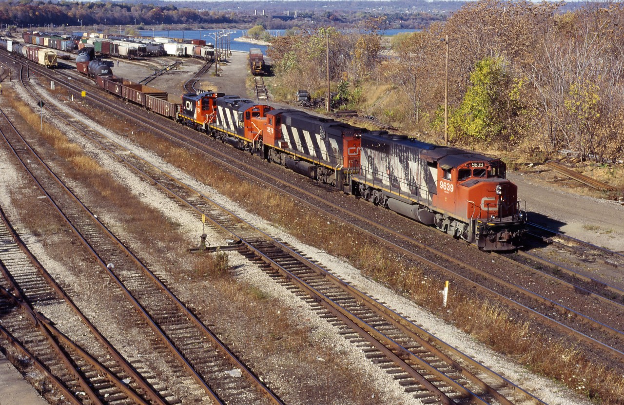 What looks like MacMillan Yard-Niagara Falls train 449 works Hamilton Yard on fine fall day in 1994. Power is GP40-2W 9636, M420W 3578, GP9RM 4141, and SW1200RS 1375. I don' recall whether the last two units were set off in Hamilton or went on to the Falls for use on locals in the Niagara region.