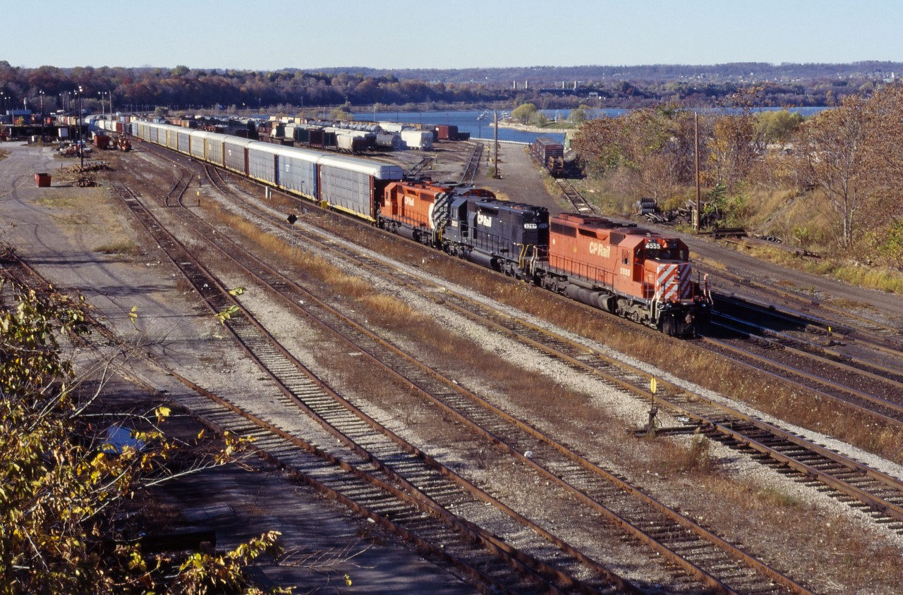 CP 522,detouring over CN between Hamilton Jct and Niagara Falls, passes CN's Stuart Street yard behind SD40 5555, ex-NS SD40-2 3253, and CP SD40-2 5656.