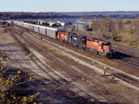 CP 522,detouring over CN between Hamilton Jct and Niagara Falls, passes CN's Stuart Street yard behind SD40 5555, ex-NS SD40-2 3253, and CP SD40-2 5656.