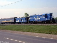 Conrail GP9 7432 and caboose 21541 are coupled with CN Track Geometry Car 15000 (in VIA colours), pictured on the CR CASO Sub a few miles east of Windsor. At the time CN was evaluating the CASO for purchase, which it would do a few years later in a joint acquisition with CP in 1985.