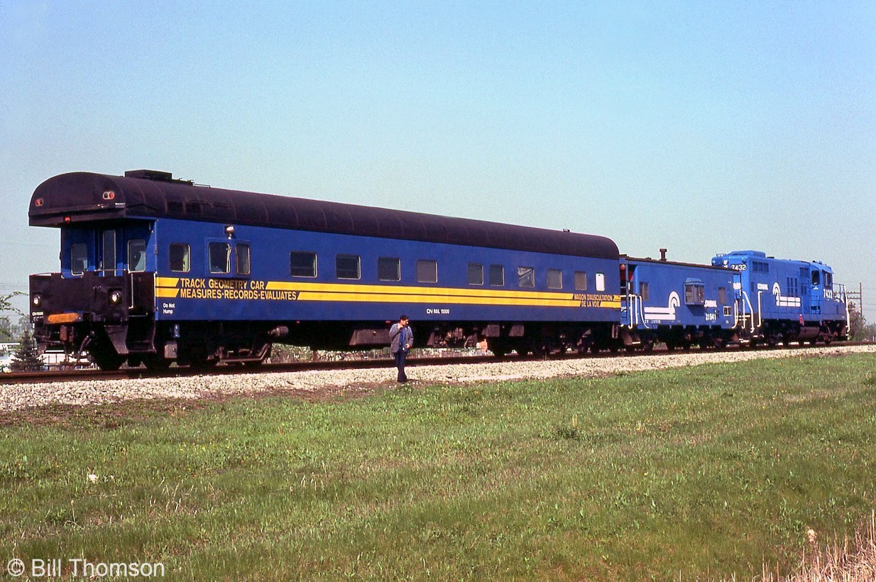 An alternate photo of the rear of the train giving a better view of CN Track Geometry Car 15000, trailing Conrail GP9 7432 and caboose 21541 on the CR CASO Sub a few miles east of Windsor. At the time CN was evaluating the CASO for purchase, which it would do a few years later in a joint acquisition with CP in 1985.

Front view of the train: http://www.railpictures.ca/?attachment_id=34758.