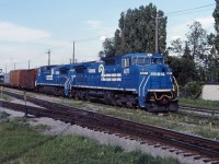 A very short SECP (Selkirk, NY-CP St. Luc Montreal) passes through St. Lambert, Quebec on a fine summer evening. The train is detouring over CN due to the Oka Crisis which has closed the Conrail-CP route through Kahnawake. C40-8Ws 6071 and 6083 power the four car train.