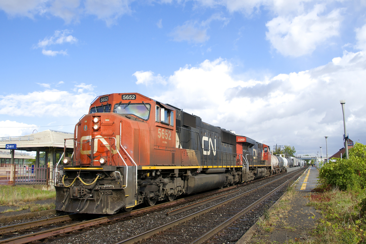 CN 5652 & CN 2269 are the power on CN X321, seen passing Dorval Station just as the sun comes out after a downpour. This as-needed train originates at Southwark Yard and often lifts more cars at Coteau, which was the case with this edition.