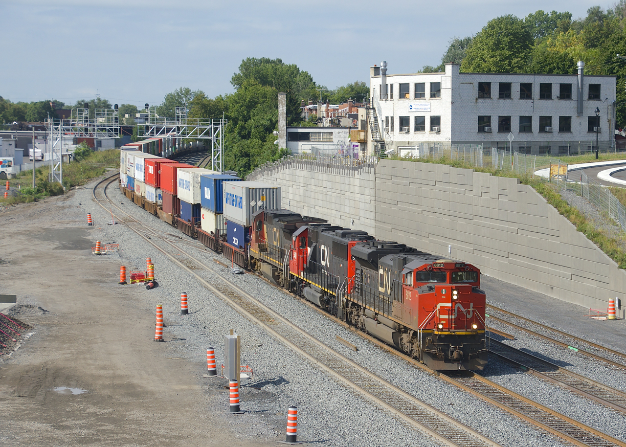 Since this past Monday, all VIA Rail and CN trains have been taking a new right-of-way between St-Henri and Turcot West In Montreal. A long time in coming, this new right-of-way was necessitated by the ongoing reconstruction of the Turcot interchange and nearby connecting highways. Here CN 120 with CN 8812, CN , CN 2121 & DPU CN 2221 take the north track of the new right-of-way during a brief period of sunshine. The old right-of-way curves off to the left here, just past the signal bridges.