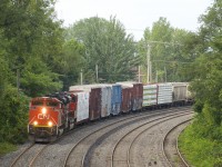 A pair of SD70M-2's (CN 8879 & CN 8916) have 83 cars for interchange to the NECR in tow (81 of them loads) as CN 324 rounds a curve on CN's Montreal Sub.