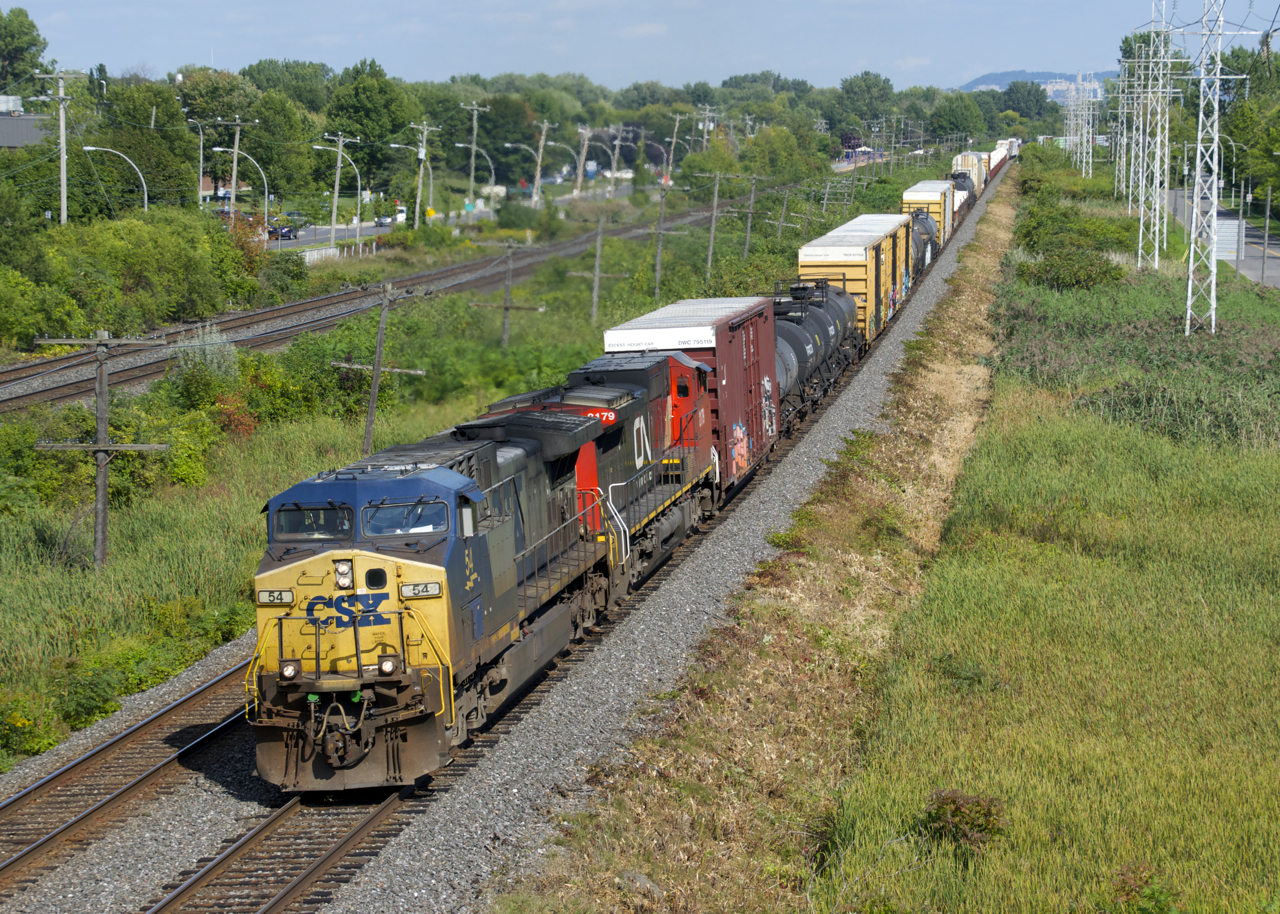 CSXT 54 & CN 2179 lead CN 327 through Pointe-Claire with 55 cars to be set off at Coteau and the rest of the train for interchange to CSXT.