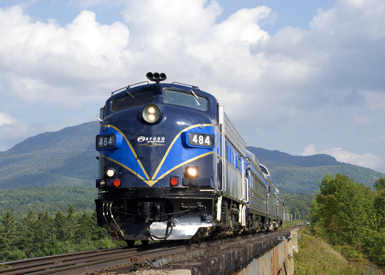With its namesake Mont-Orford looming in the background, the Orford Express is crossing the Eastman trestle before changing directions and heading east to Sherbrooke. Leading is the only FL9 in use in Canada.
