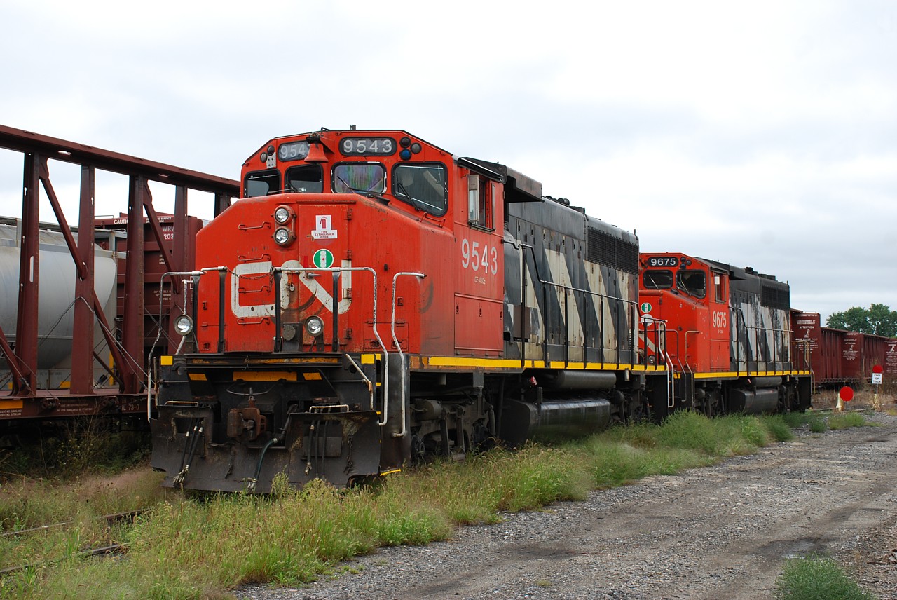 CN 9543 and 9675 were set off in Brantford yard by 385 on Monday.  They have most likely arrived to be the first locomotives assigned to the Hagersville Subdivision when CN takes back operations between Brantford and Garnet on September 18.  CN 9675 was originally built for GO Transit and the green paint it previously wore is showing through the CN paint in a lot of locations.