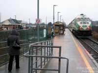 Before it was sent back to Boise for conversion by builder MotivePower Industies into a dual-engined Tier-4 emissions compliant "MP54" oddball, GO 647 was just another of the many MP40PH-3C units populating the fleet. Here it is doing its thing, putting that 4000 horsepower 16-710G to work pushing evening train #805 (Toronto to Barrie) out of Rutherford GO station in the rain, as passengers flock from the platforms to their waiting cars and buses at the station loop and parking lot. The photographer was always cutting it close doing these kind of departing shots, as his usual bus (pictured waiting by the station, one of the ever-present boring D40LF's) usually left 1-2 minutes after seeing the train pull out.