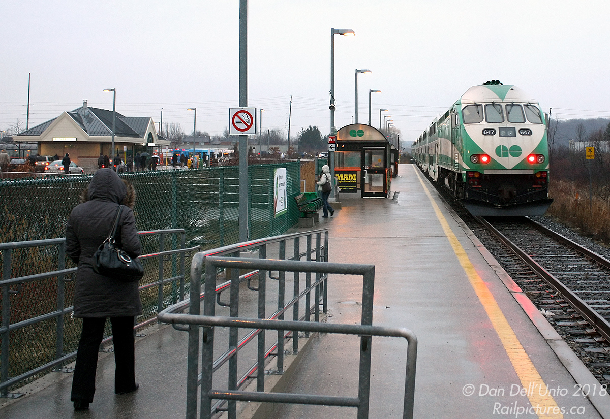 Before it was sent back to Boise for conversion by builder MotivePower Industies into a dual-engined Tier-4 emissions compliant "MP54" oddball, GO 647 was just another of the many MP40PH-3C units populating the fleet. Here it is doing its thing, putting that 4000 horsepower 16-710G to work pushing evening train #805 (Toronto to Barrie) out of Rutherford GO station in the rain, as passengers flock from the platforms to their waiting cars and buses at the station loop and parking lot. The photographer was always cutting it close doing these kind of departing shots, as his usual bus (pictured waiting by the station, one of the ever-present boring D40LF's) usually left 1-2 minutes after seeing the train pull out.