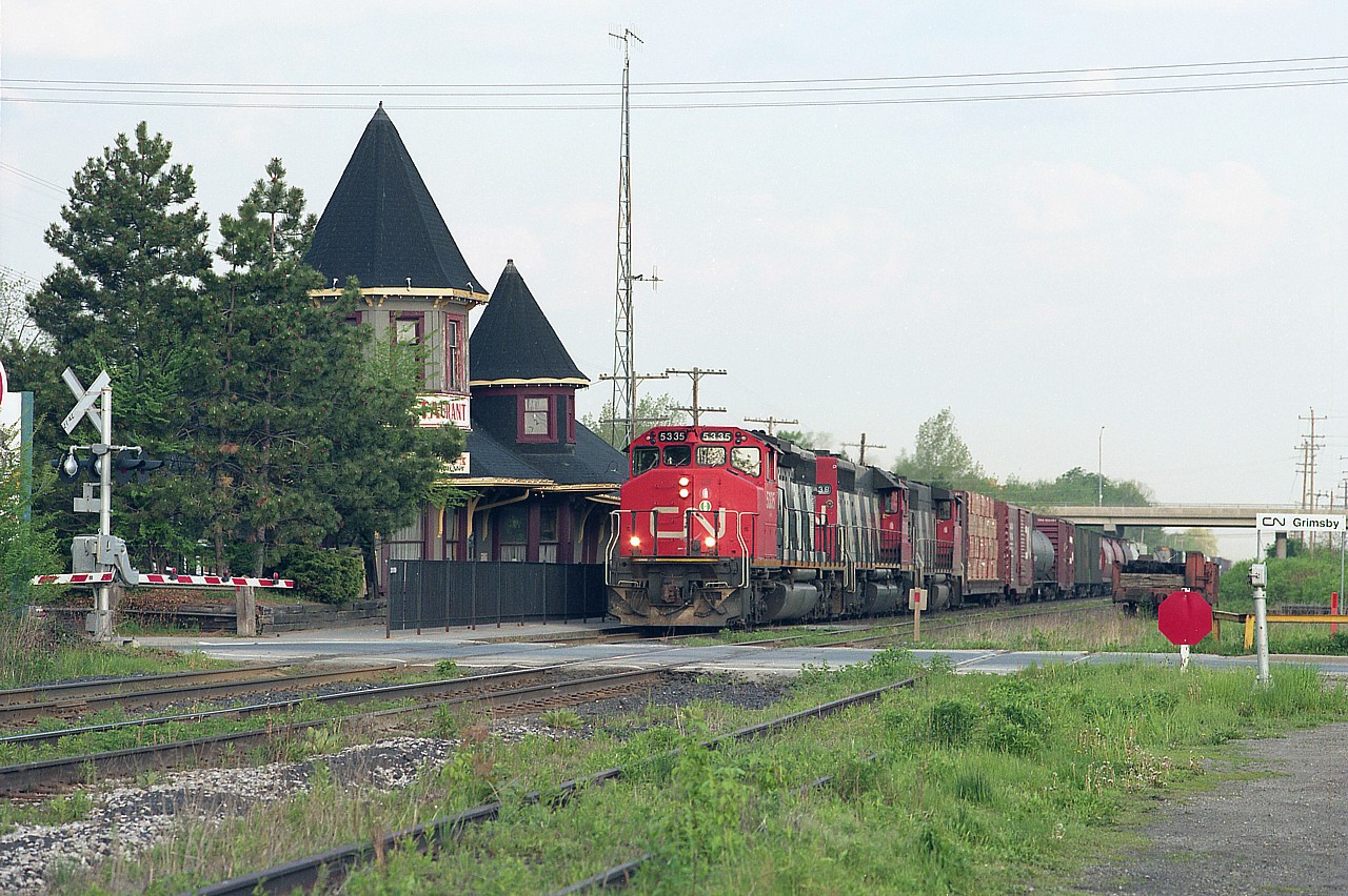 This is a typical train with typical power back in the 1990s as it rolls toward Port Robinson. I posted this because the old Grimsby station is an elegant place and is missed by the townsfolk. It was destroyed by an electrical fire about 6 months after this was taken. New Years Eve, Dec 31/94 it went up and was a total loss.
CN 5335, 5038 and 9649 is the power.  Memories..............